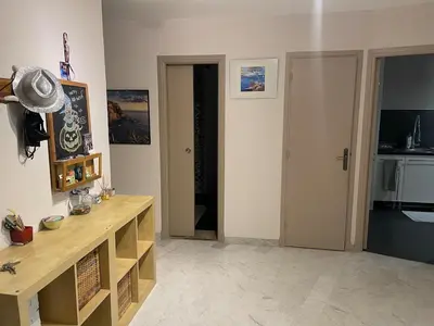 a kitchen with a wooden counter in a room at Large 2-room bright sea view near airport in Nice