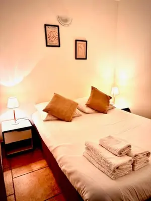a bedroom with a bed with two towels on it at DOMAINE LOU BEL AZUR - Paisible in Saint-Laurent-du-Var