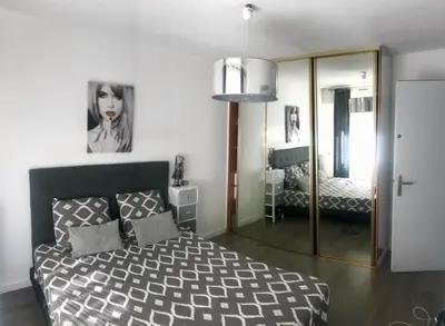a bedroom with a blue bed with a blue comforter at 3 pièces calme 5 mn Port in Nice