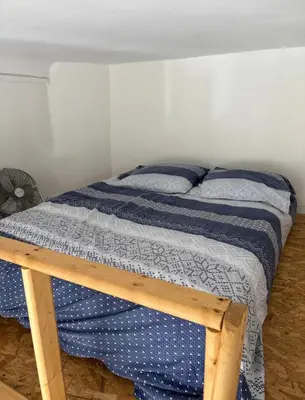 a bedroom with a bed with a blue comforter at Joli studio cœur de Nice in Nice