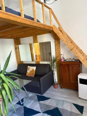 a living room with a couch and a loft at Joli studio cœur de Nice in Nice
