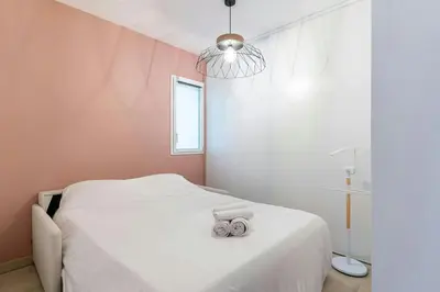 a bedroom with a bed with two towels on it at Azur Panoramique – Calme Vue Mer proche Nice in Saint-Laurent-du-Var