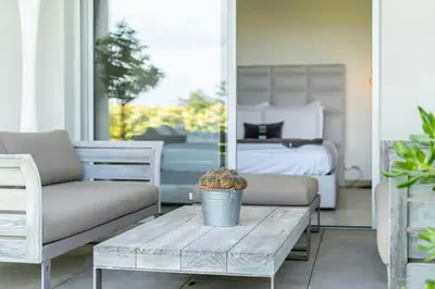 a living room with a couch and a coffee table at Azur Panoramique – Calme Vue Mer proche Nice in Saint-Laurent-du-Var