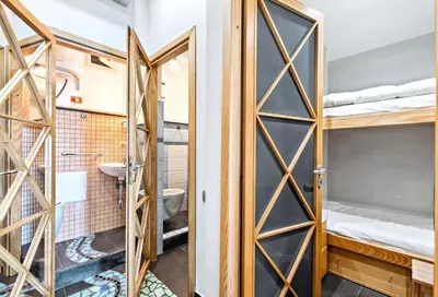 a room with bunk beds and a bathroom at Vue Mer Prestige in Villefranche-sur-Mer