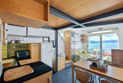 a kitchen and living room with a view of the ocean at Vue Mer Prestige in Villefranche-sur-Mer