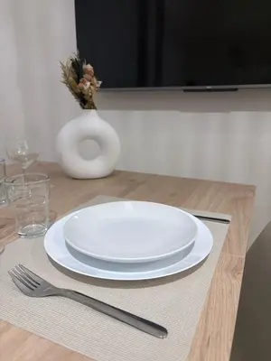 a table with a plate and a fork and knife at Studio cosy Le Vismara in Nice