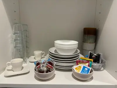 a pile of plates and cups on a table at Studio cosy Le Vismara in Nice