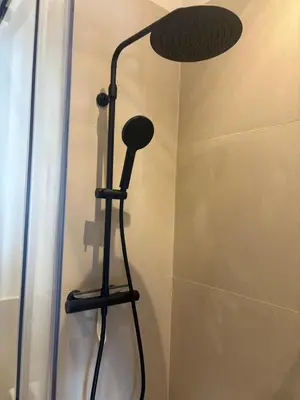 a shower with a shower head in a bathroom at Studio cosy Le Vismara in Nice