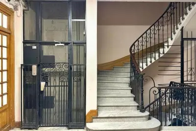 a set of stairs with a wrought iron gate at Loft Carré d'or - Wifi, climatisation, 4 personnes in Nice
