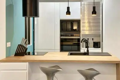 a kitchen with a counter with a sink and appliances at Loft Carré d'or - Wifi, climatisation, 4 personnes in Nice