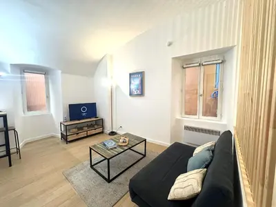 a living room with a couch and a table at Studio vieux nice coulee verte in Nice