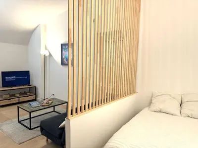 a living room with a bed and a table at Studio vieux nice coulee verte in Nice