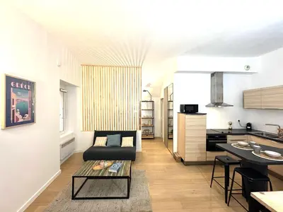 a living room with a couch and a table at Studio vieux nice coulee verte in Nice