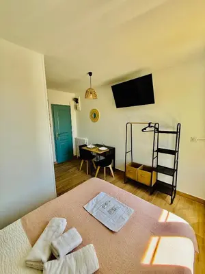a bedroom with a bed with two towels on it at Sweethome Massena in Nice