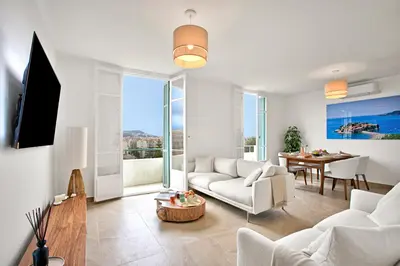 a living room with a couch and a table at Modern Apartment With City View - Happy Rentals in Nice