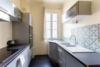 a small kitchen with a sink and a window at Charmant appartement avec terrasse en plein cœur de Nice à deux pas de la mer ! in Nice