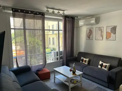 a living room with a couch and a table at New central nice sea down town in Nice