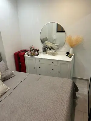 a bedroom with a bed with a mirror and a red suitcase at New central nice sea down town in Nice