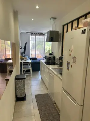 a kitchen with a white refrigerator and a table at New central nice sea down town in Nice