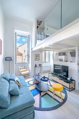 a living room with a blue couch and a table at Loft hyper-centre de Nice in Nice