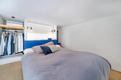 a bedroom with a large bed with a blue headboard at Loft hyper-centre de Nice in Nice
