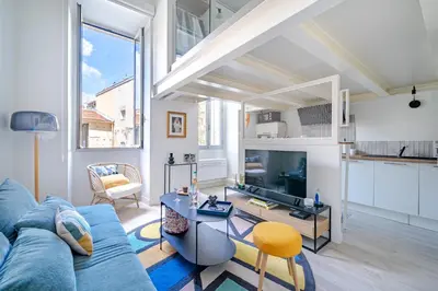 a living room with a blue couch and a table at Loft hyper-centre de Nice in Nice