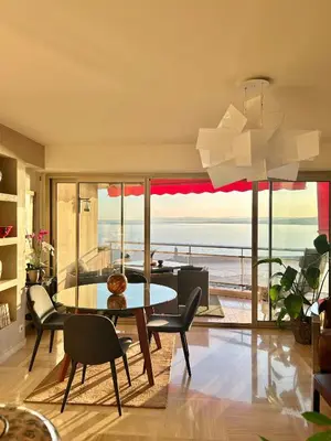 a dining room with a table and a view of the ocean at Magnifique appartement - Vue mer in Nice