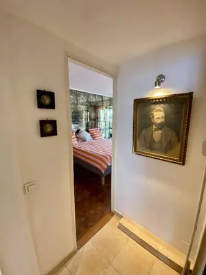 a hallway with a painting of a man on the wall at NICE 2P Panoramic Sea View Wi-Fi AC in Nice