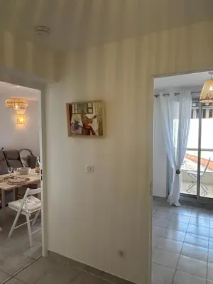 a living room with a table and a dining room at Appartement cosy à 200 m de la mer in Cagnes-sur-Mer