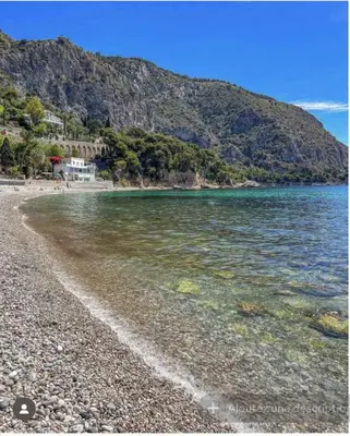 a beach with a rocky shore next to the water at Petite Villa Eze Bord de Mer in Èze