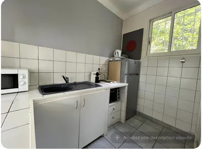 a white kitchen with a sink and a refrigerator at Petite Villa Eze Bord de Mer in Èze