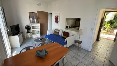a living room with a couch and a table at Petite Villa Eze Bord de Mer in Èze