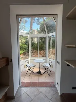 a room with a table and chairs and a window at Cozy Villa Saint-Jean-Cap-Ferrat in Saint-Jean-Cap-Ferrat