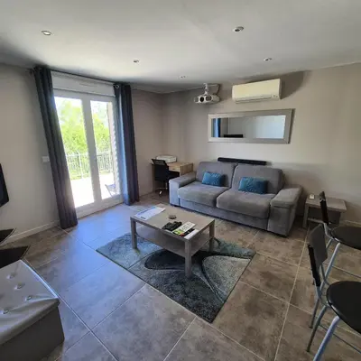 a living room with a couch and a table at Saint-Jeannet Studio apartment near Nice in Saint-Jeannet