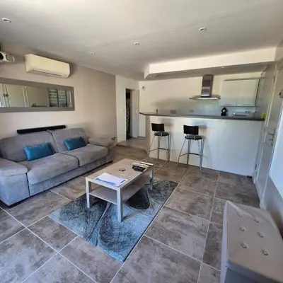a living room with a couch and a table at Saint-Jeannet Studio apartment near Nice in Saint-Jeannet