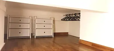 an empty room with a closet with wine racks at joli studio proche tram et au calme in Nice