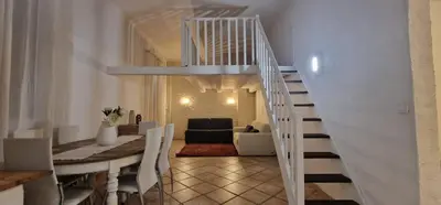 a white staircase in a living room with a couch at Sunset Villa atypical with air conditioning in Nice