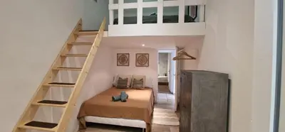 a bedroom with a bunk bed and a staircase at Sunset Villa atypical with air conditioning in Nice