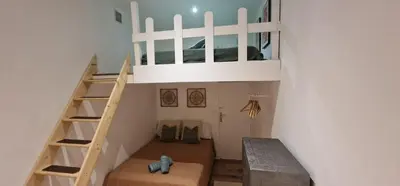 a small room with a ladder and a stair case at Sunset Villa atypical with air conditioning in Nice