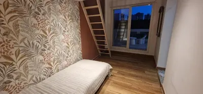 a room with a couch and a wall with a curtain at Sunset Villa atypical with air conditioning in Nice