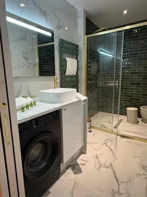 a bathroom with a washing machine and a sink at MOON 25 in Nice