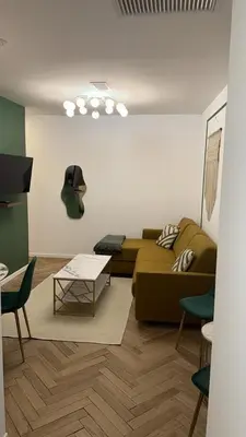 a living room with a couch and a table at MOON 25 in Nice