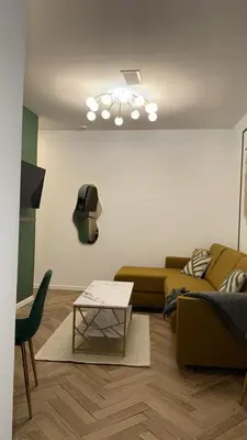 a living room with a couch and a table at MOON 25 in Nice