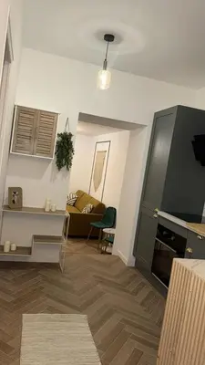 a living room with a couch and a table at MOON 25 in Nice