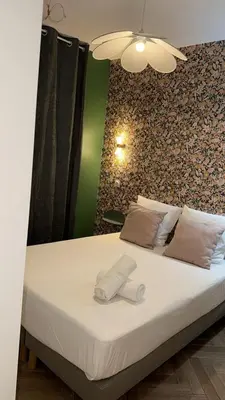 a bed in a room with a green wall at MOON 25 in Nice