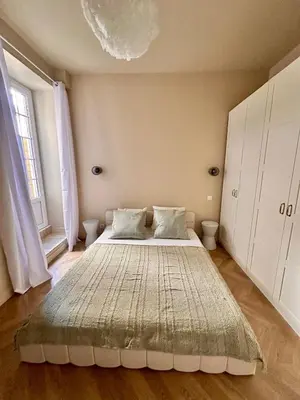 a bedroom with a large bed in a room at Le Petit Palace in Nice