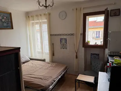 a small bedroom with a bed and a window at Daghsen in Nice