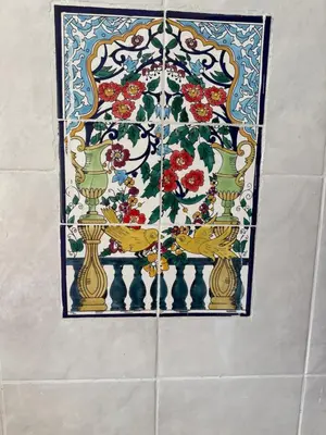 a mosaic window with vases on a wall at Daghsen in Nice