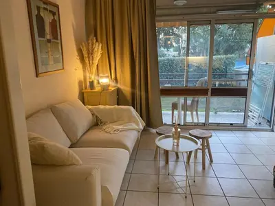 a living room with a couch and a table at Studio 50M de la mer in Saint-Laurent-du-Var