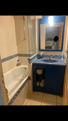 a bathroom with a sink and a tub and a mirror at Studio 50M de la mer in Saint-Laurent-du-Var